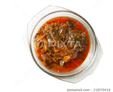 Isolated Thai curry called Moo Chamuang curry or Pork curry with Garcinia Cowa or Cowe leaves on white background. The traditional Thai curry is in cleared bowl. Top view food image. Isolated Thai curry called Moo Chamuang curry or Pork curry with Garcinia Cowa or Cowe leaves on white background. The traditional Thai curry is in cleared bowl. Top view food image. 118570418