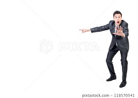 Shocked man in suit pointing aside. White background. Shocked man in suit pointing aside. White background. 118570541