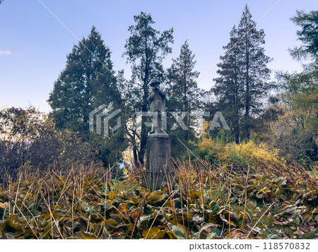 Random statue in the autumn forest on a sunny day Random statue in the autumn forest on a sunny day 118570832