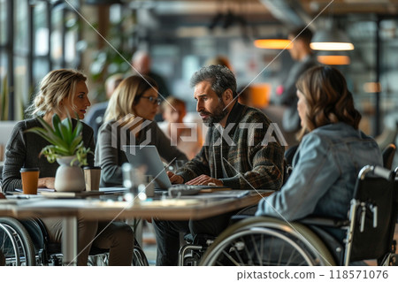 Inclusive office environment with man in wheelchair collaborating with colleagues Inclusive office environment with man in wheelchair collaborating with colleagues 118571076