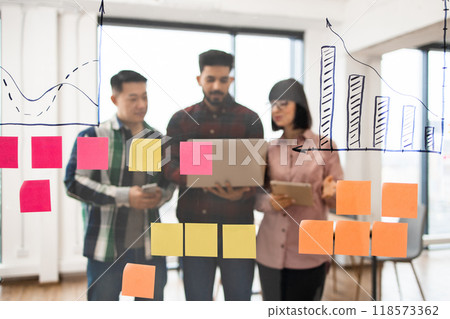 Business team brainstorming with sticky notes and charts 118573362