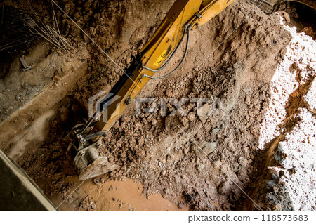A significant pile of ground is being excavated by a bulldozer A significant pile of ground is being excavated by a bulldozer 118573683