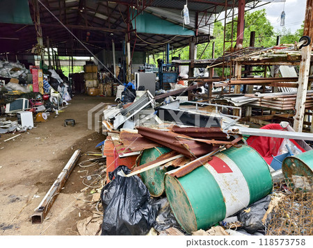 A pile of garbage with a bucket, rope, bottles, and other items at a landfill A pile of garbage with a bucket, rope, bottles, and other items at a landfill 118573758