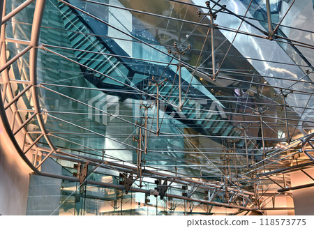 A modern tall building that features a significant amount of glass 118573775