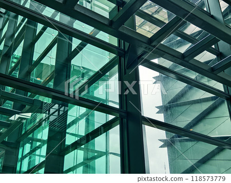 A modern tall building that features a significant amount of glass 118573779