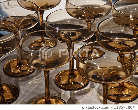 Elegant champagne glasses are arranged on a tray on a table Elegant champagne glasses are arranged on a tray on a table 118573804