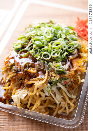 Delicious okonomiyaki with fried noodles topped with green onions Delicious okonomiyaki with fried noodles topped with green onions 118573826