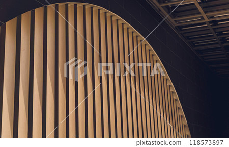 A structure featuring wooden slats on construction site contributing to its architectural style 118573897
