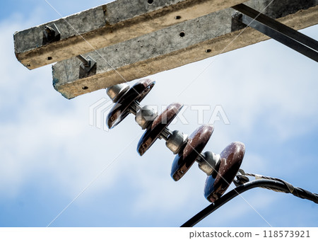 Various electrical equipment is set against a bright blue sky 118573921