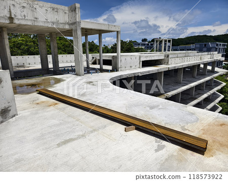 Large building with a roof pool of water under construction 118573922