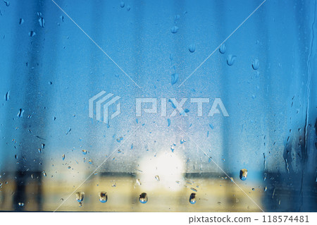 water droplets running on a double glazed window 118574481