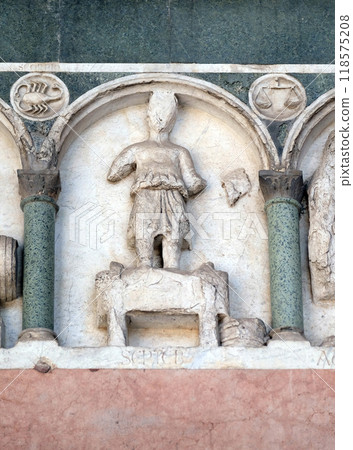September, detail of the bass-relief representing the Labor of the months of the year, portal of the Cathedral of St Martin in Lucca, Italy 118575208