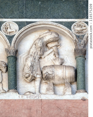 October, detail of the bass-relief representing the Labor of the months of the year, portal of the Cathedral of St Martin in Lucca, Italy October, detail of the bass-relief representing the Labor of the months of the year, portal of the Cathedral of St Martin in Lucca, Italy 118575209