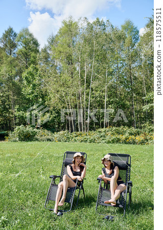 Woman enjoying sauna in the great outdoors Woman enjoying sauna in the great outdoors 118575511