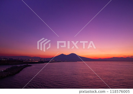 Naples, Campania, Republic of Italy, Southern Europe. Mount Vesuvius at dawn over the Bay of Naples from Santa Lucia. 118576005