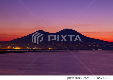 Naples, Campania, Republic of Italy, Southern Europe. Mount Vesuvius at dawn over the Bay of Naples from Santa Lucia. 118576009