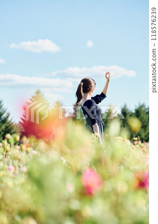 Woman standing in a flower field Woman standing in a flower field 118576239