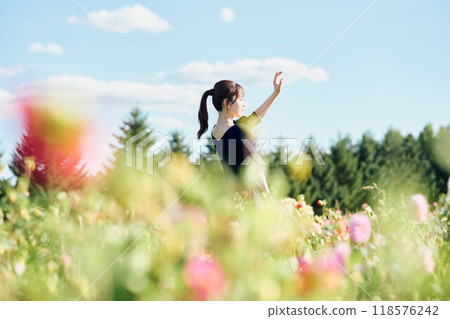 Woman standing in a flower field 118576242