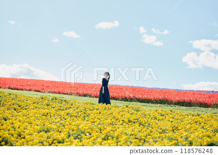 Woman standing in a flower field 118576248