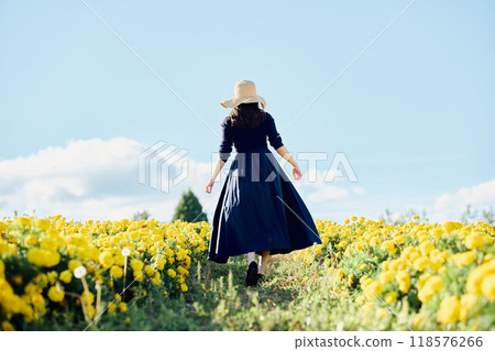 Woman walking in a flower field Woman walking in a flower field 118576266
