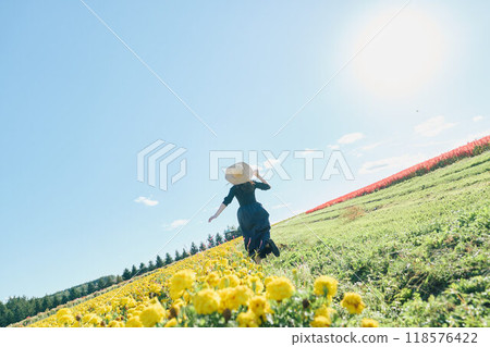 Woman running in a flower field 118576422