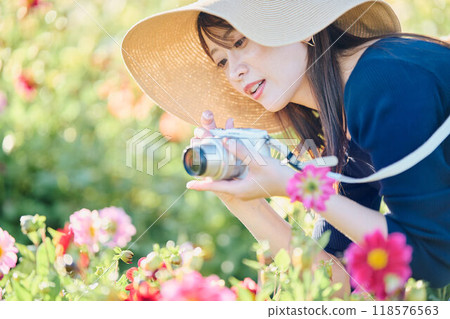 A woman shooting flowers A woman shooting flowers 118576563