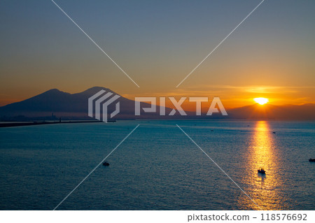 Southern Europe, Italy, Campania, Naples, Bay of Naples, Mount Vesuvius and the Morning Light Path at Sunrise from Santa Lucia 118576692