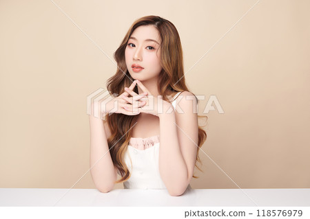 Beautiful young asian woman with clean fresh skin on beige background, Face care, Facial treatment, Cosmetology, beauty and spa, Asian women portrait. 118576979