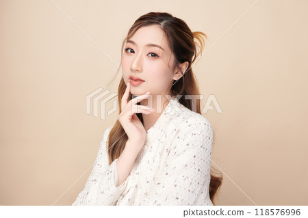 Beautiful young asian woman with clean fresh skin on beige background, Face care, Facial treatment, Cosmetology, beauty and spa, Asian women portrait. 118576996