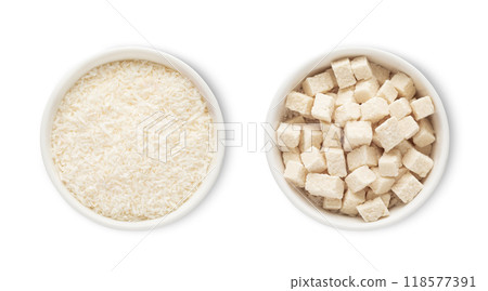 Bowls with sweet dried organic coconut flakes and bites isolated on white background.Top view. 118577391