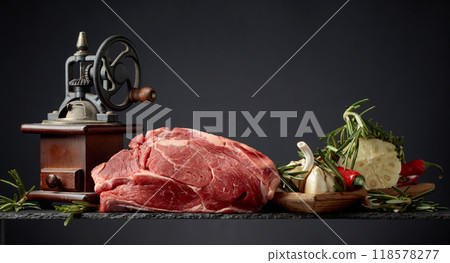 Raw beef meat steaks with rosemary, garlic, and pepper. Raw beef meat steaks with rosemary, garlic, and pepper. 118578277