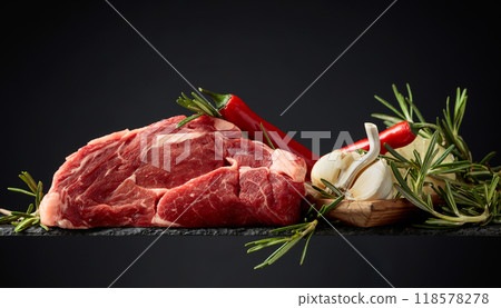 Raw beef meat steaks with rosemary, garlic, and pepper. Raw beef meat steaks with rosemary, garlic, and pepper. 118578278