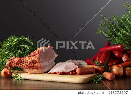 Smoked pork and various sausages on a kitchen table. 118578307