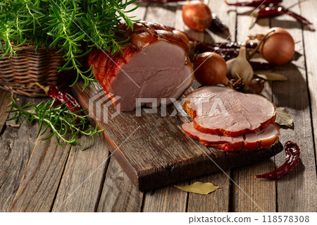 Smoked pork ham on a wooden table. 118578308