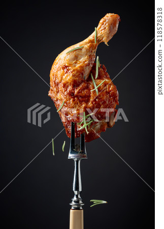 Hot chicken drumstick on a fork. 118578318