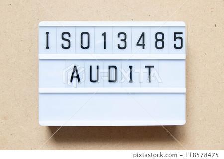Lightbox with word ISO13486 audit on wood background Lightbox with word ISO13486 audit on wood background 118578475