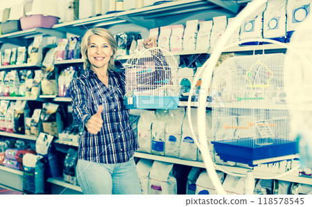 Portrait of mature woman purchasing bird cage in petshop Portrait of mature woman purchasing bird cage in petshop 118578545