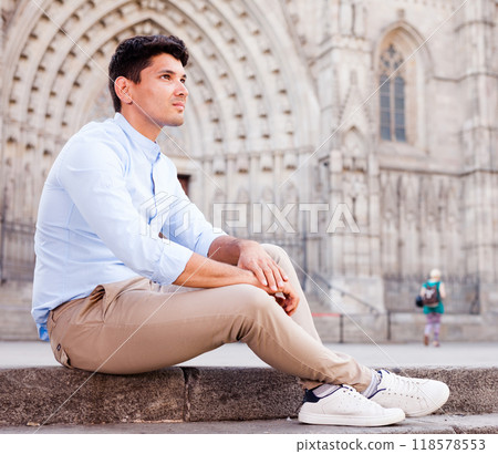 Young European guy in blue shirt walking around city Young European guy in blue shirt walking around city 118578553