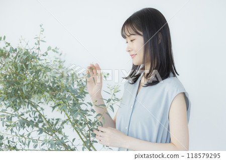 Young woman in a light blue dress Young woman in a light blue dress 118579295