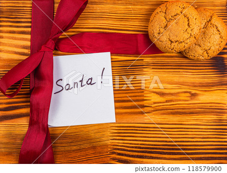 A note for Sanita with a red bow and cookies Christmas concept A note for Sanita with a red bow and cookies Christmas concept 118579900