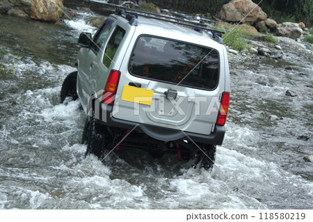 Off-road vehicle crossing a river 118580219