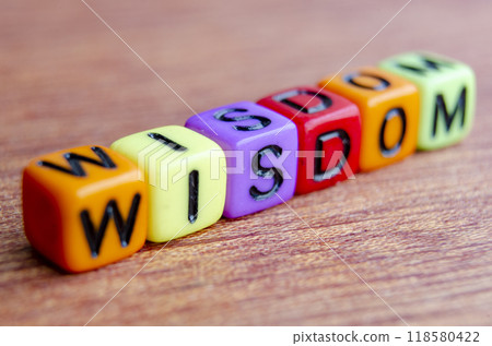 Close up of wisdom text on wooden table. Close up of wisdom text on wooden table. 118580422