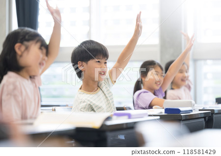 Elementary school students taking a class raise their hands and say "yes" 118581429