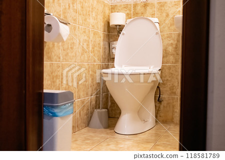 Clean bathroom with white toilet and tiled walls. 118581789