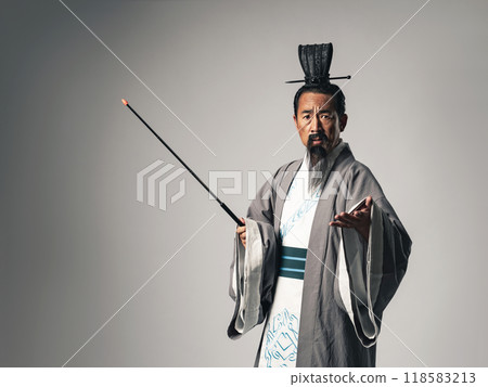 A scene where a Chinese historical figure, such as Zhuge Liang from the Romance of the Three Kingdoms, is giving a lecture at a seminar while holding a pointing stick 118583213