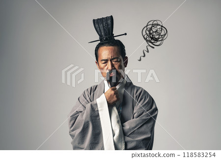 A scene in which a historical figure from China, such as Zhuge Liang from the Romance of the Three Kingdoms, is worried A scene in which a historical figure from China, such as Zhuge Liang from the Romance of the Three Kingdoms, is worried 118583254