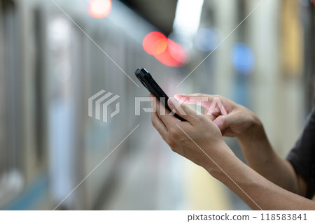 Hands of a person operating a smartphone at home Hands of a person operating a smartphone at home 118583841