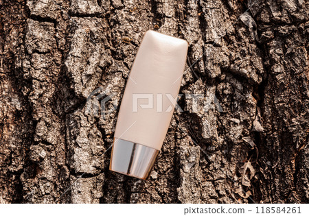 Beige Cosmetic Tube on Textured Tree Bark Background 118584261