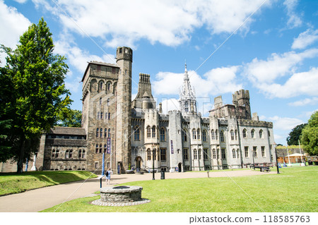 A historic brick and stone building in the grounds of Cardiff Castle under bright sunlight in Cardiff, the capital of Wales. A historic brick and stone building in the grounds of Cardiff Castle under bright sunlight in Cardiff, the capital of Wales. 118585763