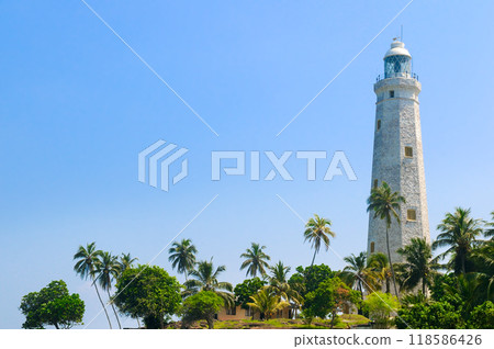 Beautiful white lighthouse Dondra Head, the southernmost cape of Sri Lanka - seen from the beach. 118586426